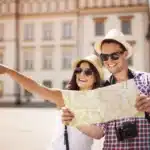 jovem casal de turistas com mapa nas mãos