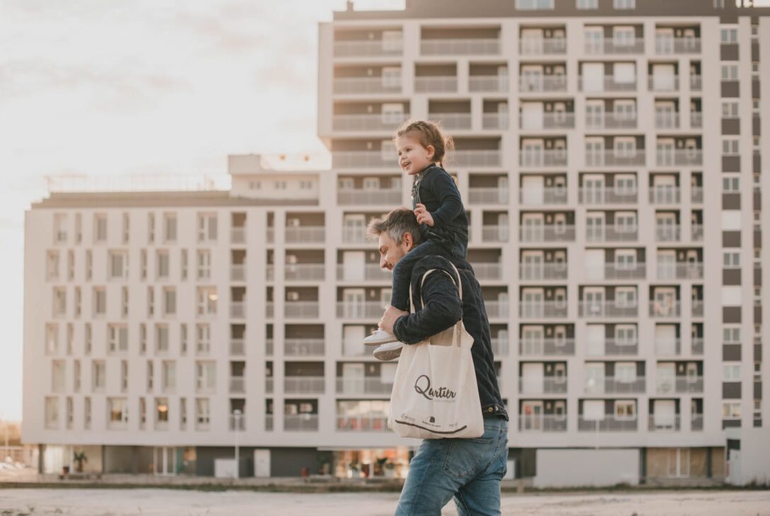 bairro-quartier-pai-caminhando-com-os-filhos-nos-ombros