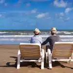 praia-do-cassino-casal-senior-sentado-em-espreguicadeiras-na-praia